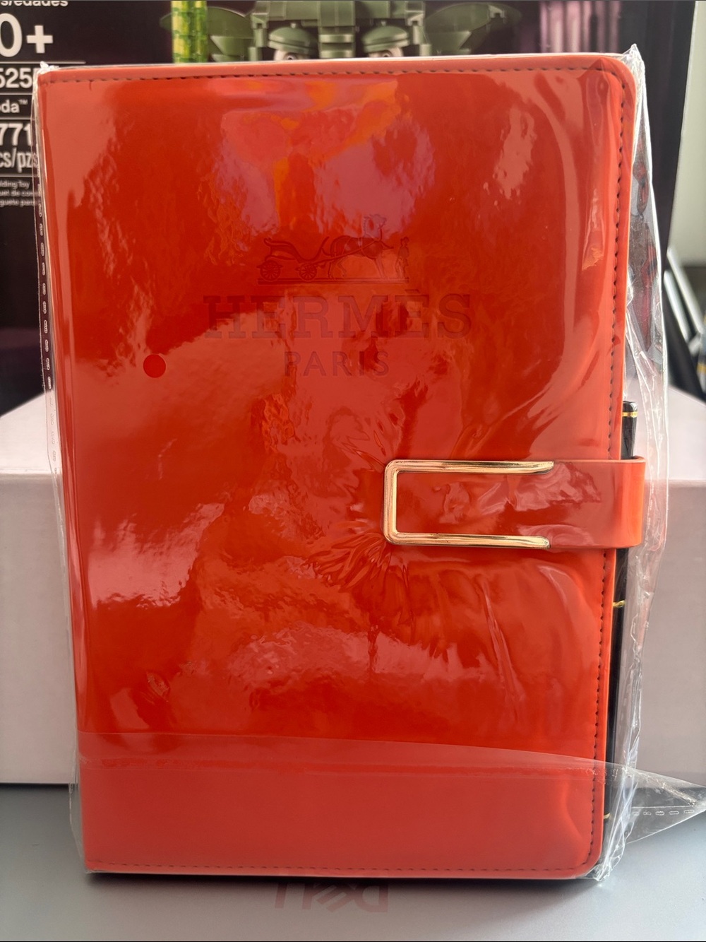 Hermes Orange Patent Notebook with Gold Buckle with pen